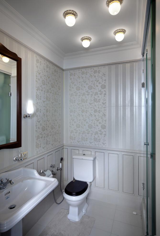 Inspiration for a classic cloakroom in Saint Petersburg with a two-piece toilet, white tiles and a pedestal sink.