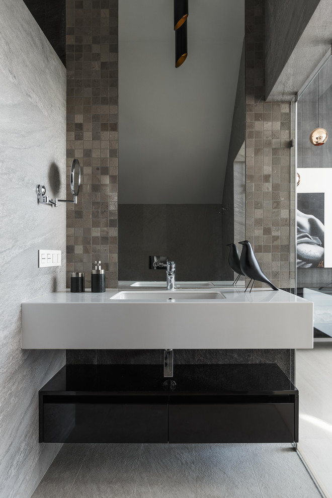 Photo of a small contemporary cloakroom in Moscow with flat-panel cabinets, black cabinets, grey tiles, porcelain tiles, porcelain flooring, a submerged sink, engineered stone worktops, grey floors and white worktops.
