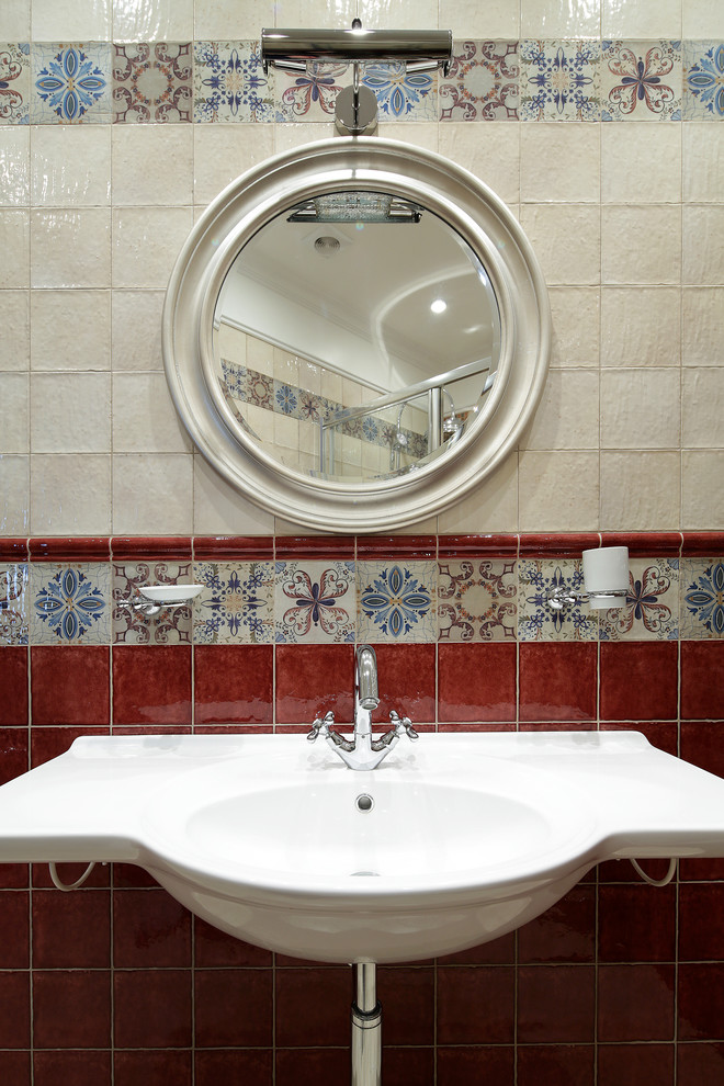 Medium sized mediterranean cloakroom in Moscow with a wall mounted toilet, multi-coloured tiles, ceramic tiles, multi-coloured walls, ceramic flooring, a console sink, beige floors and a floating vanity unit.