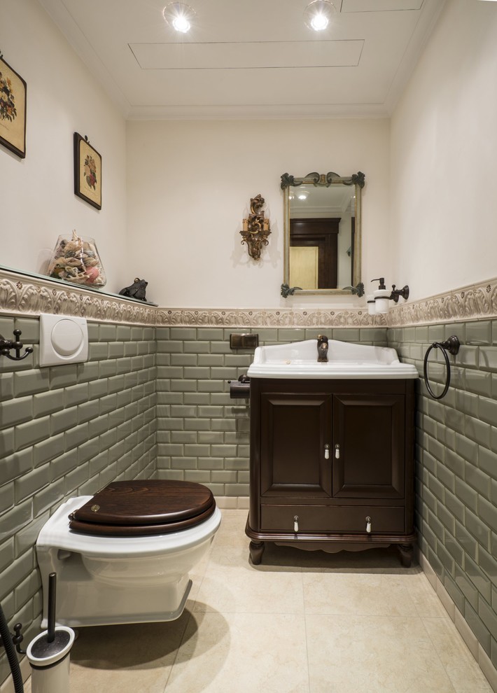 На фото: туалет в классическом стиле с темными деревянными фасадами, инсталляцией, зеленой плиткой, плиткой кабанчик, бежевым полом, фасадами островного типа, разноцветными стенами и консольной раковиной с