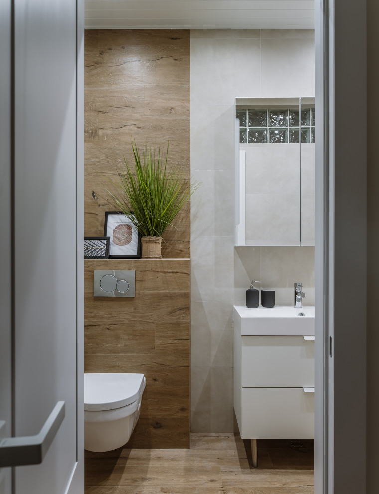 На фото: туалет в скандинавском стиле с плоскими фасадами, белыми фасадами, напольной тумбой, инсталляцией и полом из керамогранита