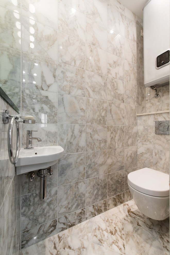 Immagine di un bagno di servizio minimal con WC sospeso e lavabo sospeso