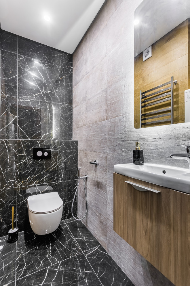 Inspiration for a medium sized contemporary cloakroom in Moscow with flat-panel cabinets, light wood cabinets, a wall mounted toilet, porcelain tiles, porcelain flooring, an integrated sink, black floors, white worktops, black tiles and a floating vanity unit.