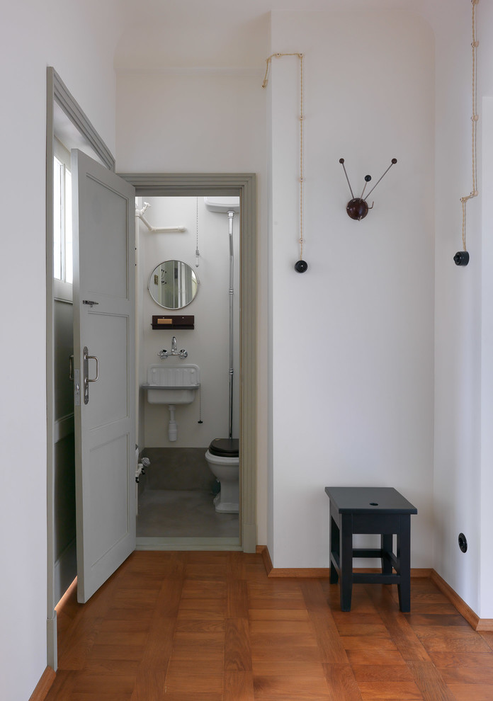 Пример оригинального дизайна: туалет в стиле ретро с белыми стенами и подвесной раковиной