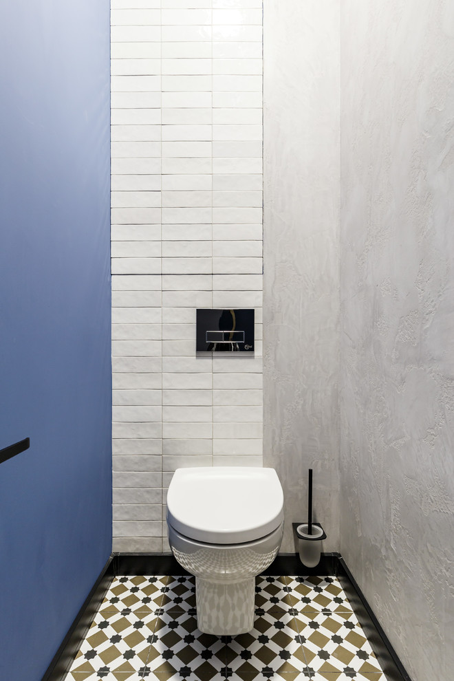 Réalisation d'un WC suspendu design avec un mur bleu et un sol en carrelage de céramique.