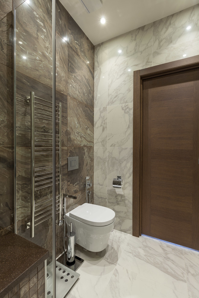 Design ideas for a small traditional cloakroom in Moscow with flat-panel cabinets, white cabinets, a wall mounted toilet, brown tiles, porcelain tiles, brown walls, porcelain flooring, a vessel sink, solid surface worktops, grey floors and brown worktops.