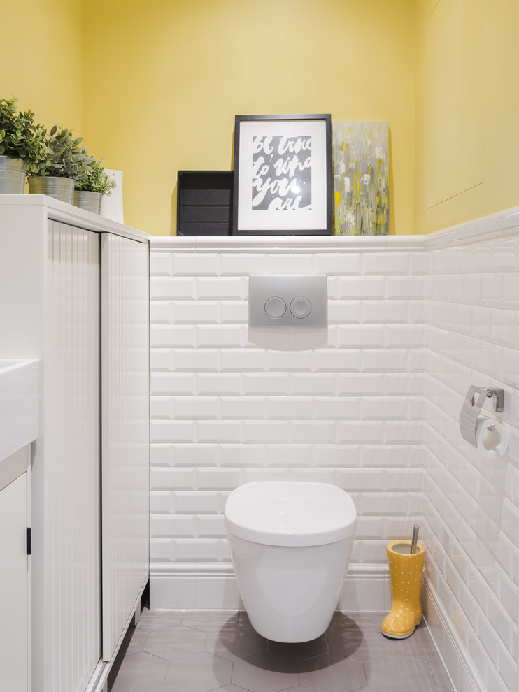 Стильный дизайн: туалет в классическом стиле с инсталляцией, белой плиткой, плиткой кабанчик и желтыми стенами - последний тренд