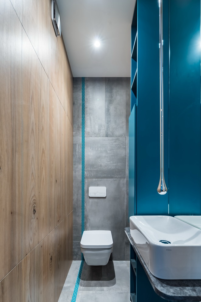 Design ideas for a contemporary cloakroom in Saint Petersburg with a wall mounted toilet, grey tiles, grey floors and grey worktops.