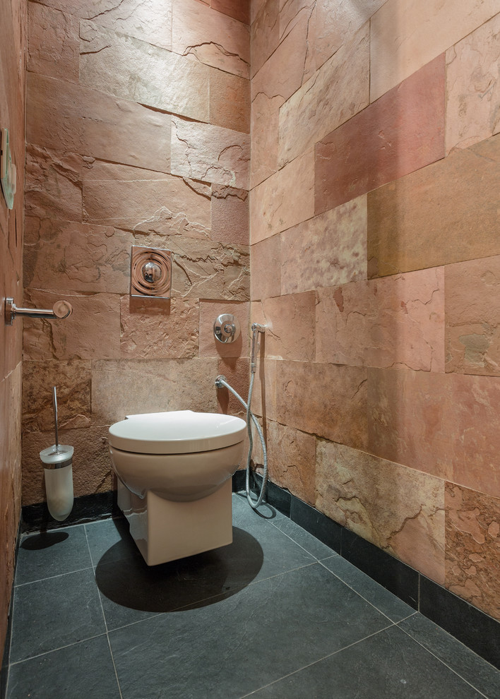 Design ideas for a small mediterranean cloakroom in Moscow with a wall mounted toilet and slate flooring.