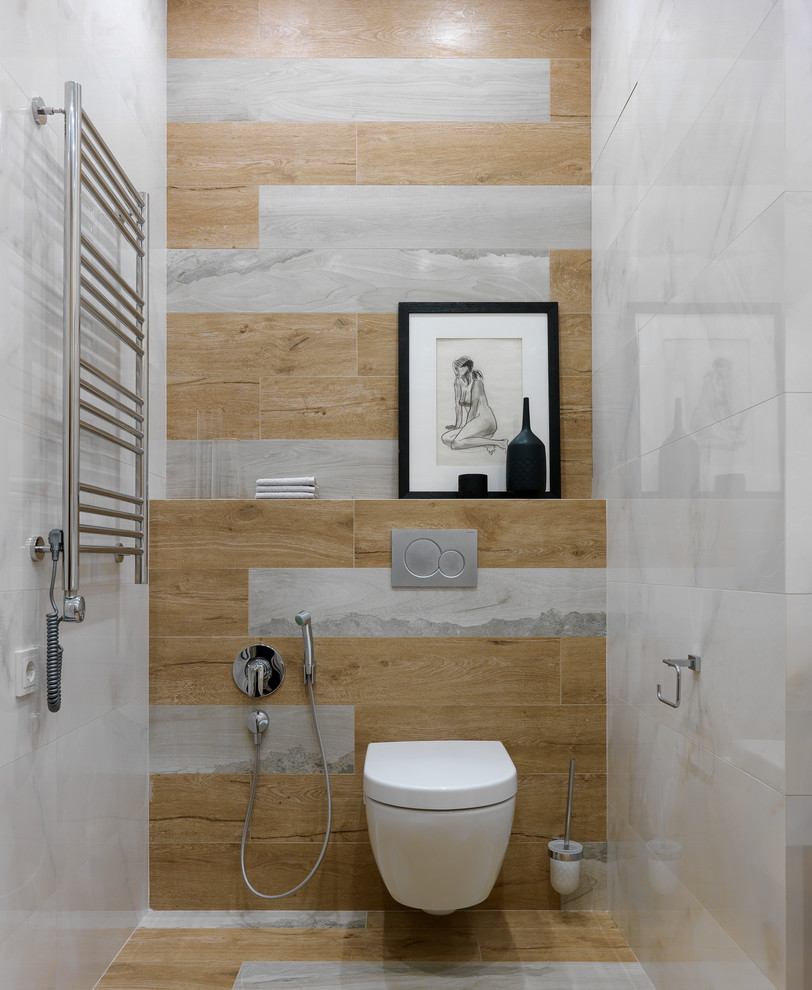 This is an example of a medium sized contemporary cloakroom in Moscow with a wall mounted toilet, porcelain tiles and porcelain flooring.