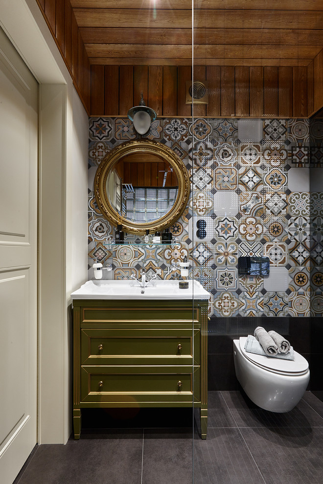 Inspiration for a bohemian cloakroom in Moscow with a wall mounted toilet, multi-coloured tiles and an integrated sink.