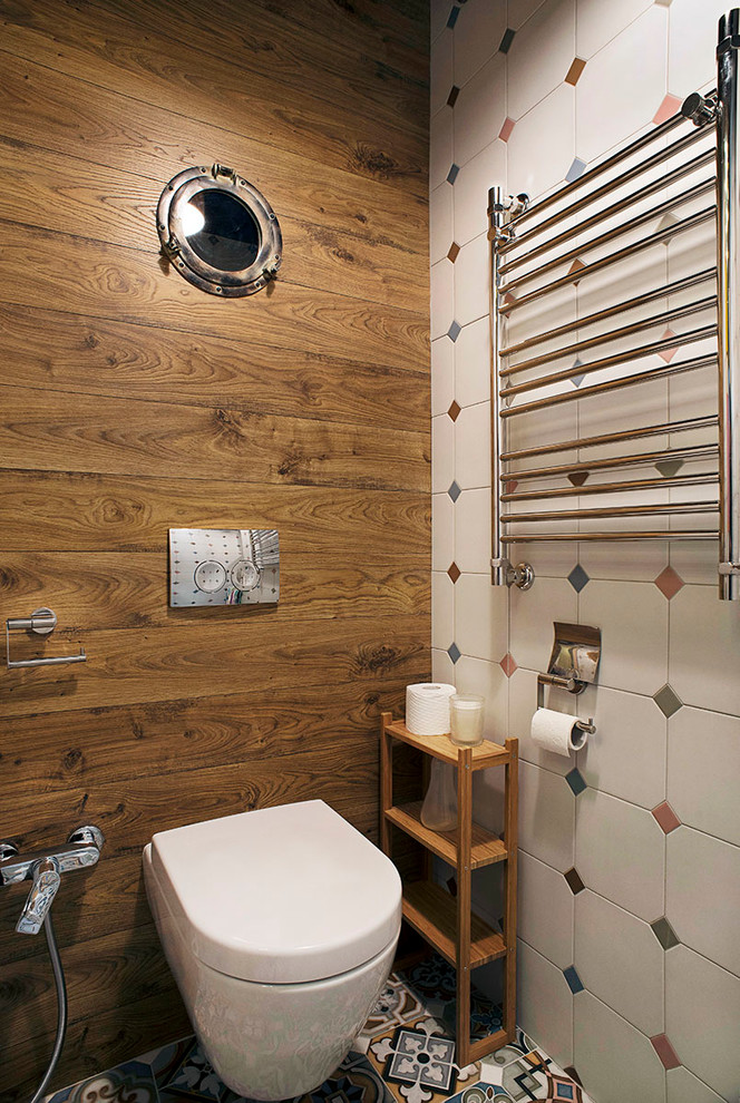 Photo of a contemporary cloakroom in Saint Petersburg with a wall mounted toilet and multi-coloured tiles.