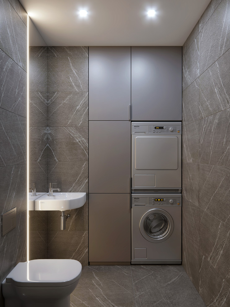 Idee per un piccolo bagno di servizio design con WC sospeso, piastrelle grigie, piastrelle in gres porcellanato, pavimento in gres porcellanato, lavabo sospeso, pavimento grigio, ante lisce, ante grigie e pareti grigie