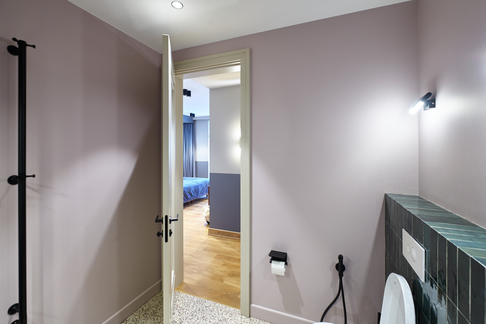 Idée de décoration pour un WC et toilettes design de taille moyenne avec un mur blanc, sol en stratifié et un sol beige.