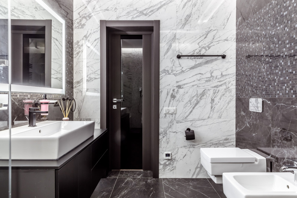 Example of a mid-sized trendy black and white tile and porcelain tile marble floor and black floor powder room design in Other with flat-panel cabinets, black cabinets, a wall-mount toilet, granite countertops, black countertops, a floating vanity and a vessel sink