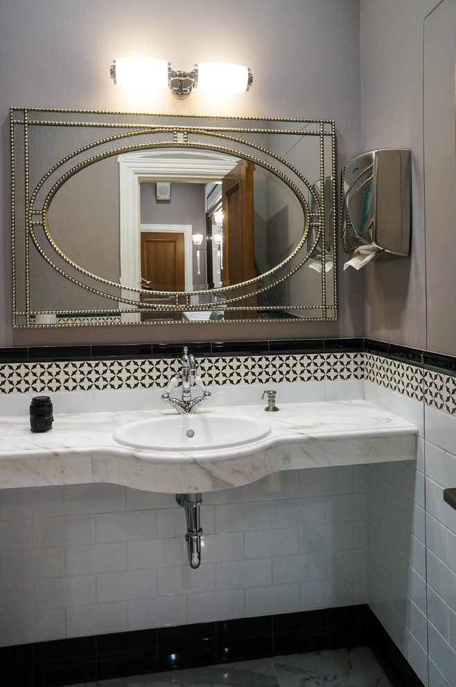 This is an example of a small classic cloakroom in Moscow with a wall mounted toilet, white tiles, ceramic tiles, brown walls, porcelain flooring, a built-in sink, marble worktops, white floors and white worktops.