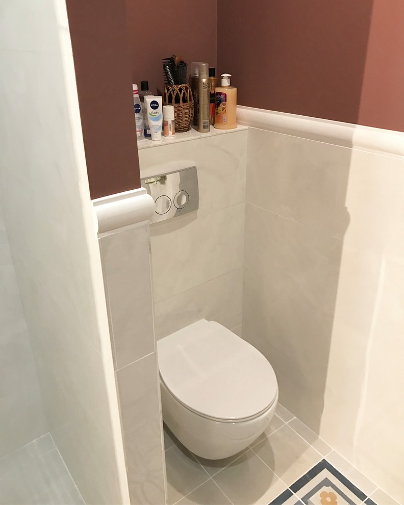 Inredning av ett modernt litet toalett, med en vägghängd toalettstol, vit kakel, keramikplattor, klinkergolv i keramik, flerfärgat golv och bruna väggar