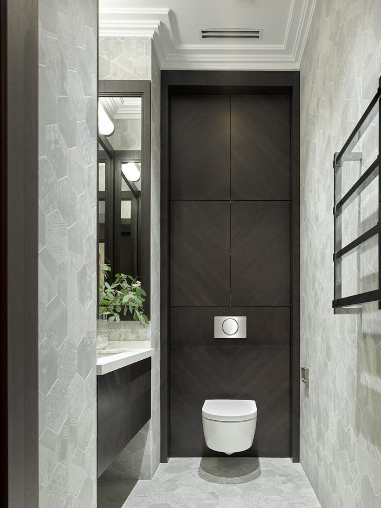Photo of a contemporary cloakroom in Moscow with flat-panel cabinets, a wall mounted toilet, a submerged sink, grey floors, white worktops, a floating vanity unit and a feature wall.
