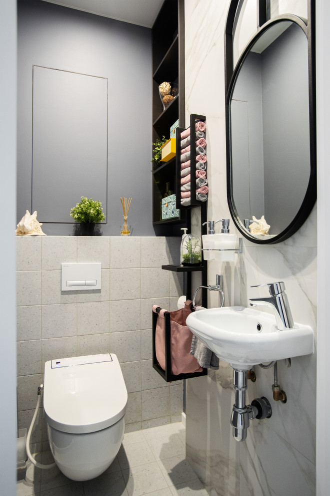 Ispirazione per un bagno di servizio contemporaneo con WC sospeso, pareti grigie e lavabo sospeso