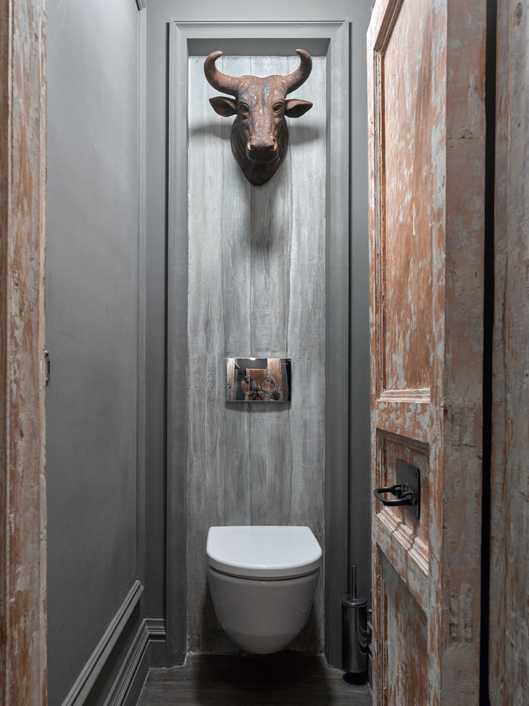 Photo of an industrial cloakroom in Moscow with a wall mounted toilet and grey walls.