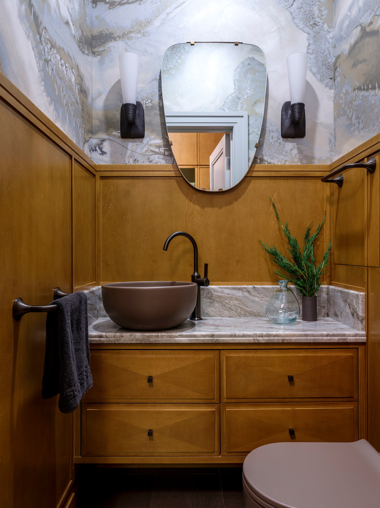 Example of a small transitional powder room design in Moscow with raised-panel cabinets, a vessel sink, marble countertops, medium tone wood cabinets and beige countertops