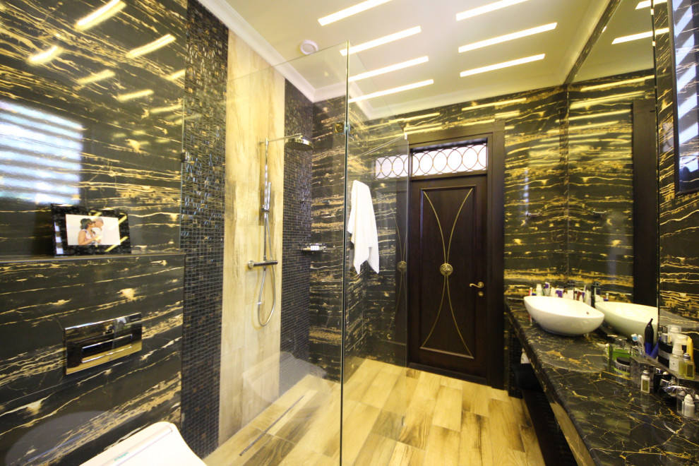 Inspiration for a mid-sized eclectic black tile and porcelain tile ceramic tile, black floor, tray ceiling and wall paneling powder room remodel in Moscow with open cabinets, white cabinets, a wall-mount toilet, black walls, a vessel sink, marble countertops, black countertops and a floating vanity