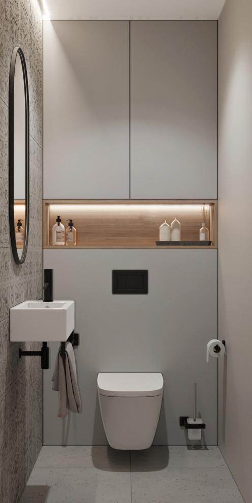 Exemple d'un petit WC suspendu tendance avec un placard à porte plane, des portes de placard grises, un carrelage gris, des carreaux de céramique, un mur gris, un sol en carrelage de porcelaine, un lavabo suspendu, un sol gris et meuble-lavabo suspendu.