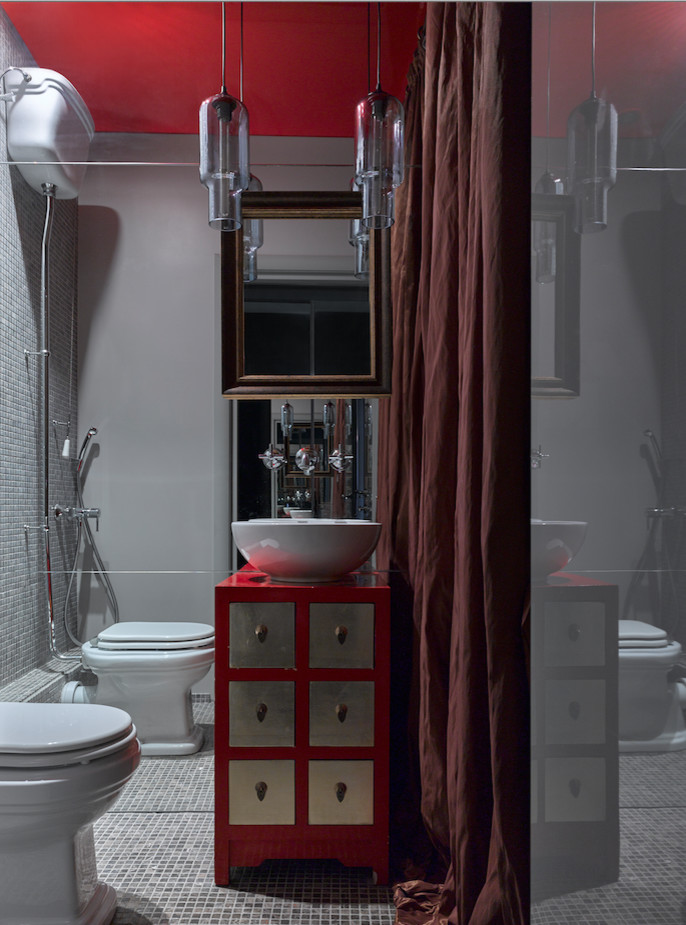 На фото: туалет в стиле фьюжн с плоскими фасадами, раздельным унитазом, серой плиткой, серыми стенами, настольной раковиной и зеркальной плиткой с