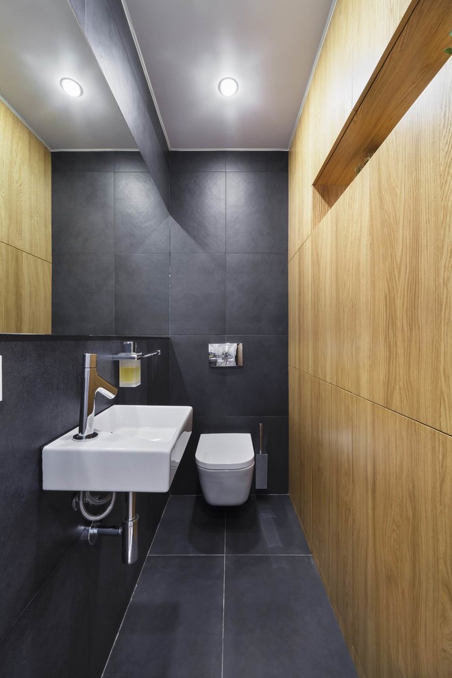Idee per un bagno di servizio contemporaneo con WC sospeso, piastrelle grigie, lavabo sospeso e pavimento grigio