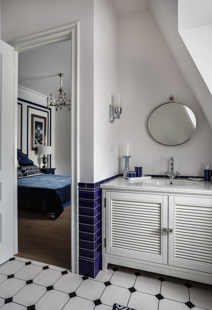 Design ideas for a small classic cloakroom in Moscow with white cabinets, stone tiles, white walls, ceramic flooring, solid surface worktops, multi-coloured floors, louvered cabinets, blue tiles and a submerged sink.