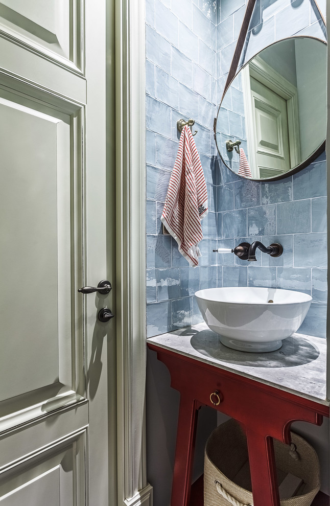 Inspiration for a small eclectic cloakroom in Moscow with red cabinets, solid surface worktops, grey tiles, a vessel sink, glass tiles, freestanding cabinets, a wall mounted toilet, grey walls, porcelain flooring, blue floors and grey worktops.