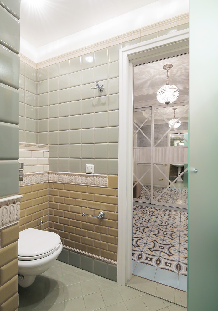 На фото: туалет в стиле неоклассика (современная классика) с инсталляцией, желтой плиткой, зеленой плиткой и плиткой кабанчик с