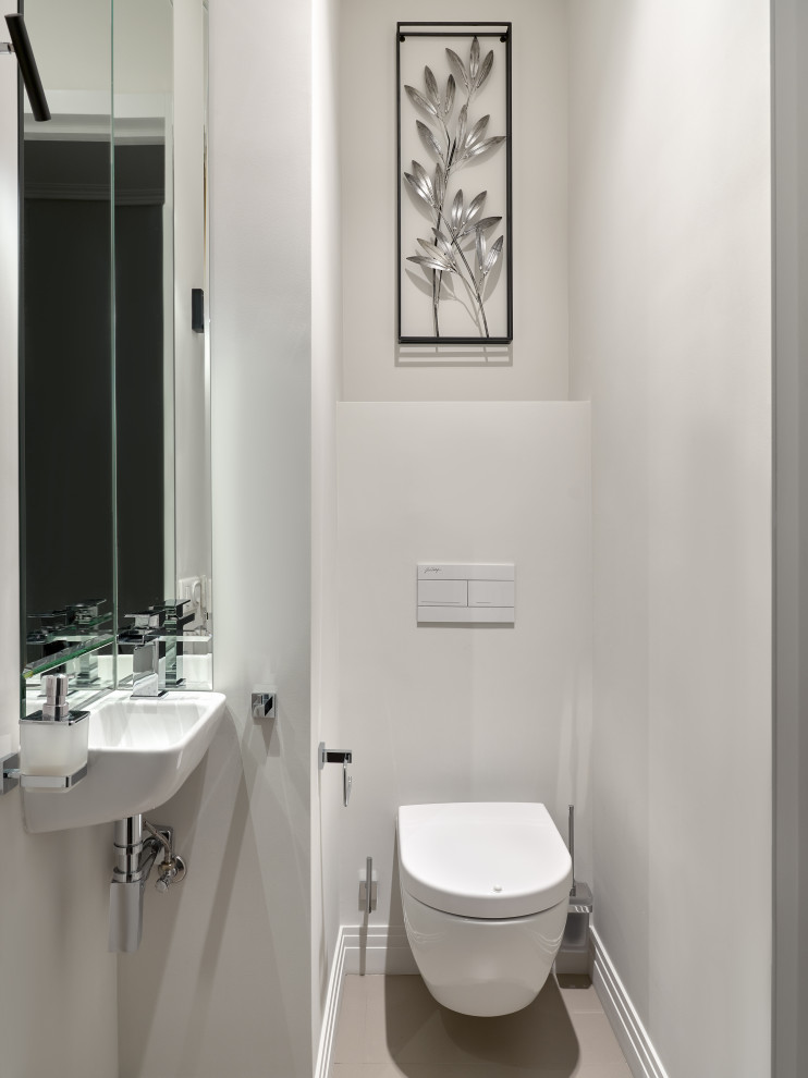Esempio di un bagno di servizio design con WC sospeso e lavabo sospeso