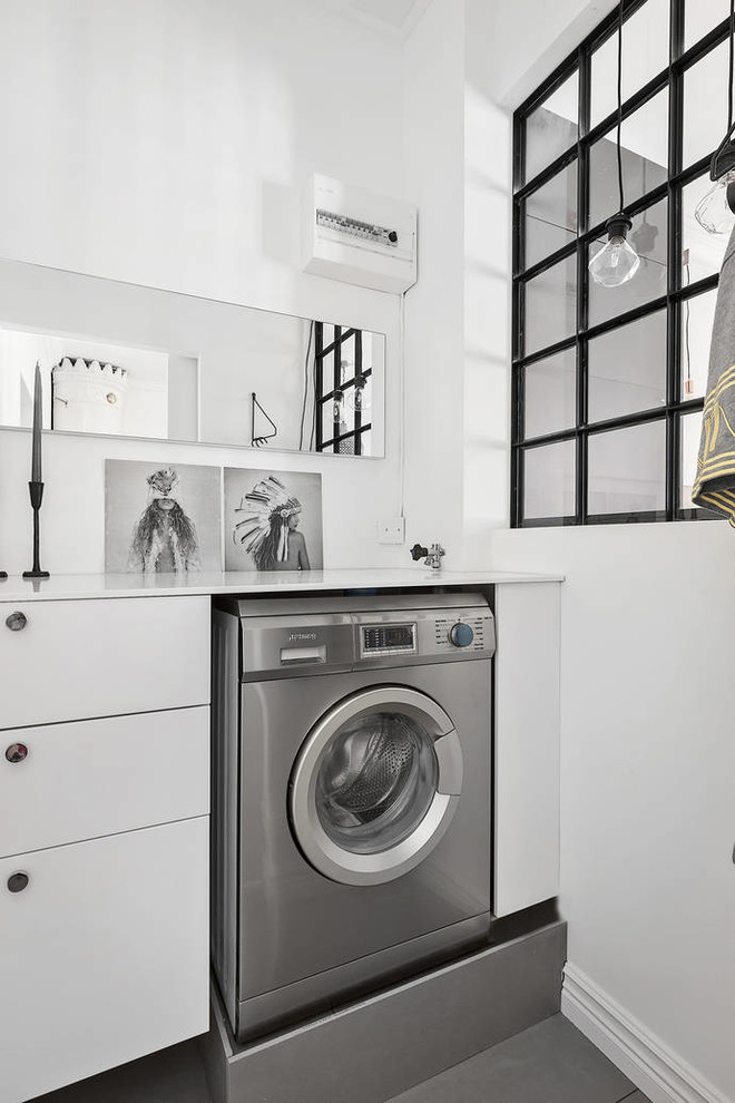 Small danish single-wall gray floor laundry room photo in Stockholm with flat-panel cabinets, white cabinets, white walls and white countertops