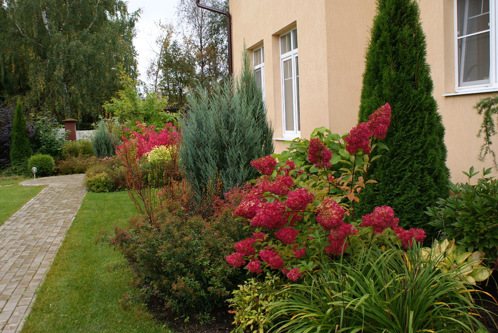 Exemple d'un jardin avant tendance de taille moyenne et l'automne avec une exposition ensoleillée et des pavés en béton.
