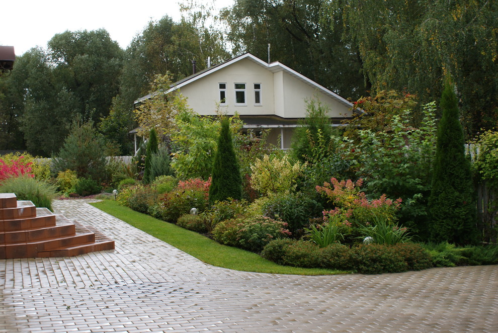 Пример оригинального дизайна: солнечный, осенний участок и сад среднего размера на переднем дворе в современном стиле с хорошей освещенностью и мощением тротуарной плиткой