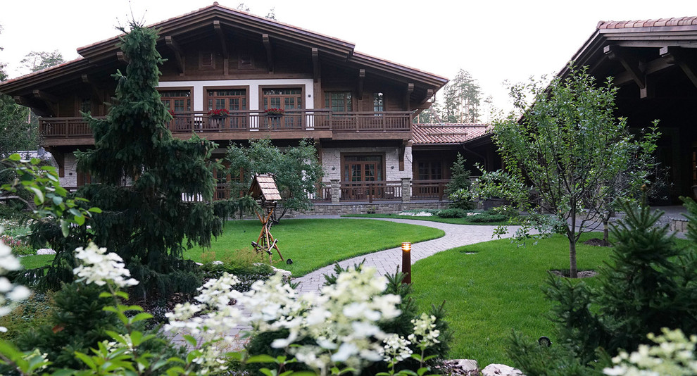 This is an example of a rustic back formal partial sun garden for summer in Moscow with a garden path and natural stone paving.
