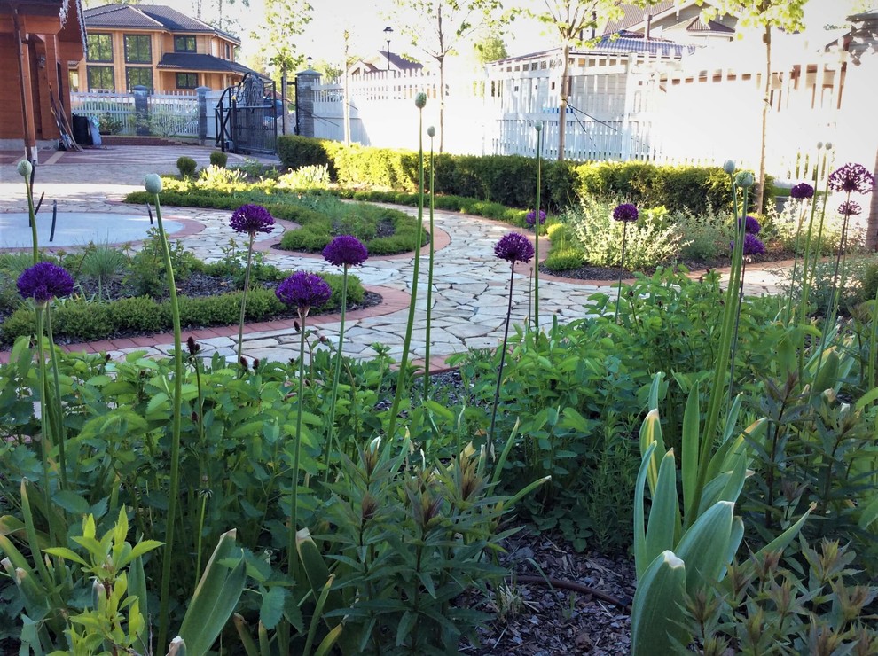 Diseño de jardín clásico renovado de tamaño medio en primavera en patio delantero con exposición total al sol y adoquines de piedra natural