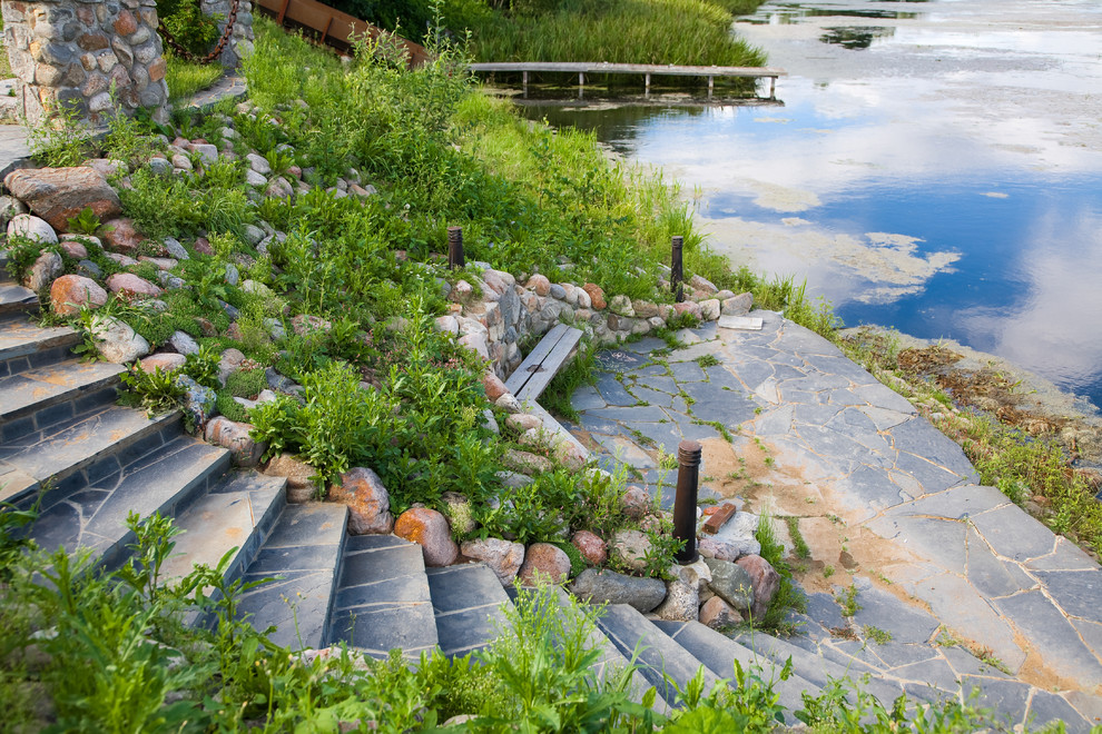 This is an example of a contemporary full sun garden seating for summer in Moscow with a pond.