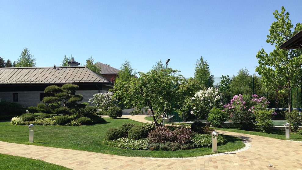 Esempio di un giardino moderno esposto in pieno sole in cortile e di medie dimensioni in primavera con pavimentazioni in pietra naturale