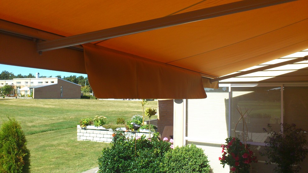 Immagine di un patio o portico scandinavo con un parasole