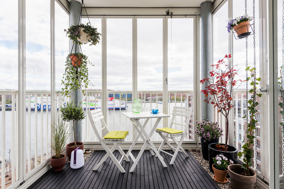 Photo of a medium sized scandi conservatory in Gothenburg with no fireplace and black floors.