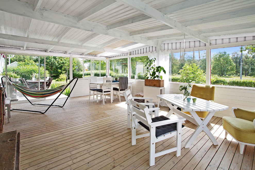 Photo of a large scandi conservatory in Other with light hardwood flooring and a standard ceiling.
