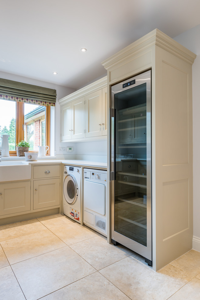 Small country u-shaped utility room in Hertfordshire with a belfast sink, beaded cabinets, grey cabinets, quartz worktops, grey walls, ceramic flooring, a side by side washer and dryer, beige floors and white worktops.