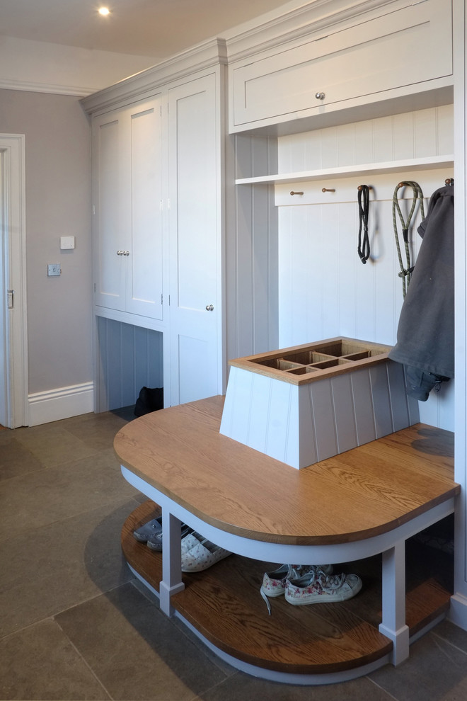 Small victorian single-wall laundry cupboard in Cambridgeshire with shaker cabinets, grey cabinets, wood worktops, grey walls, limestone flooring, beige floors and brown worktops.