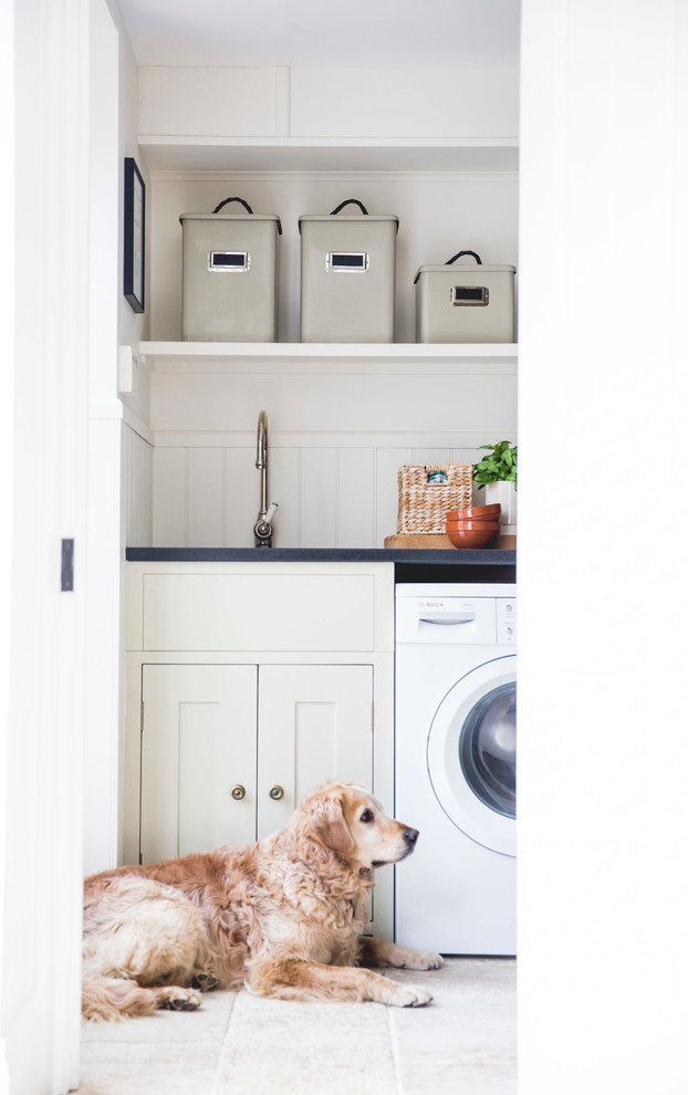 Einzeilige Landhausstil Waschküche mit Unterbauwaschbecken, Schrankfronten im Shaker-Stil, beigen Schränken, weißer Wandfarbe, weißem Boden und schwarzer Arbeitsplatte in London