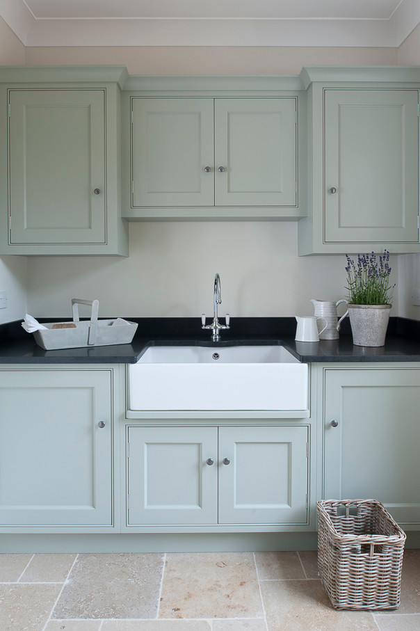 Design ideas for a medium sized classic separated utility room in Kent with a belfast sink, beaded cabinets, blue cabinets, granite worktops, white walls and limestone flooring.