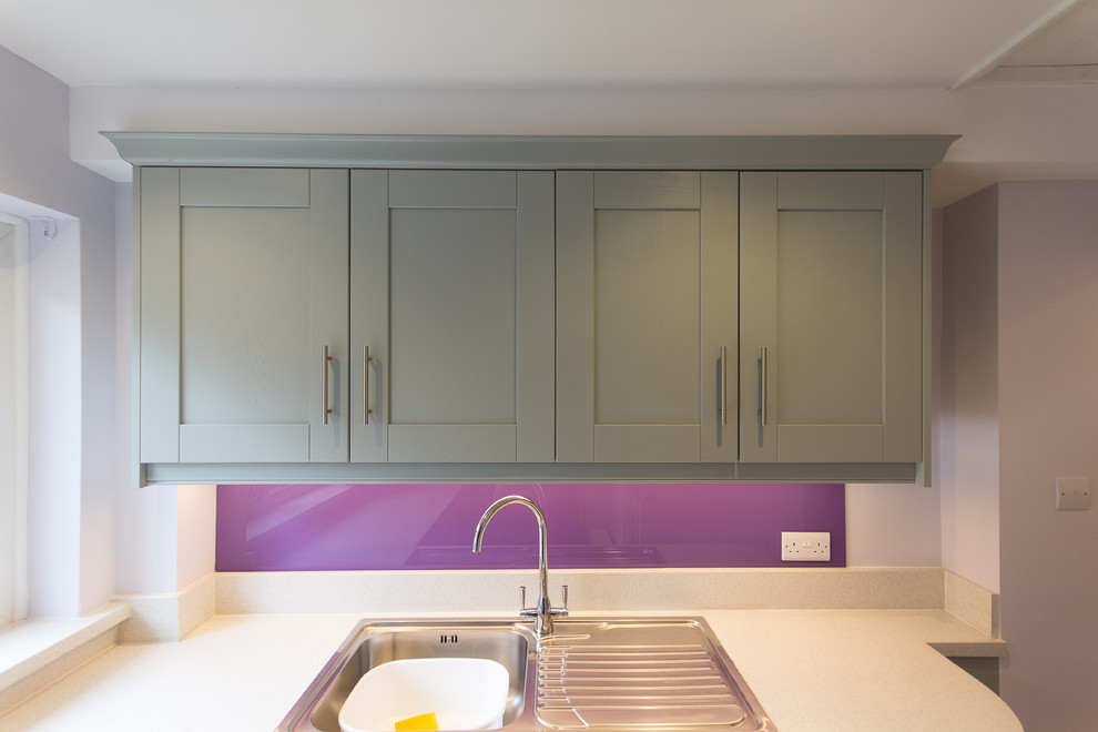 This is an example of a small modern l-shaped separated utility room in London with a single-bowl sink, shaker cabinets, grey cabinets, laminate countertops, purple walls, porcelain flooring and a side by side washer and dryer.