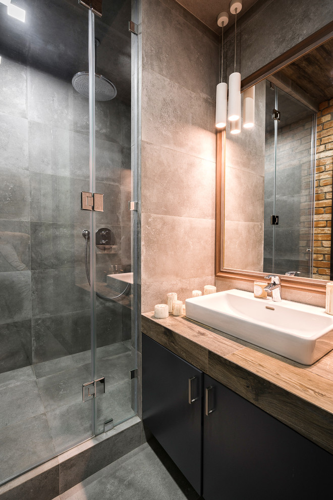 Inspiration for a medium sized contemporary shower room bathroom in Other with glass-front cabinets, dark wood cabinets, a built-in shower, a wall mounted toilet, brown tiles, porcelain tiles, grey walls, porcelain flooring, a built-in sink, tiled worktops, grey floors and a hinged door.