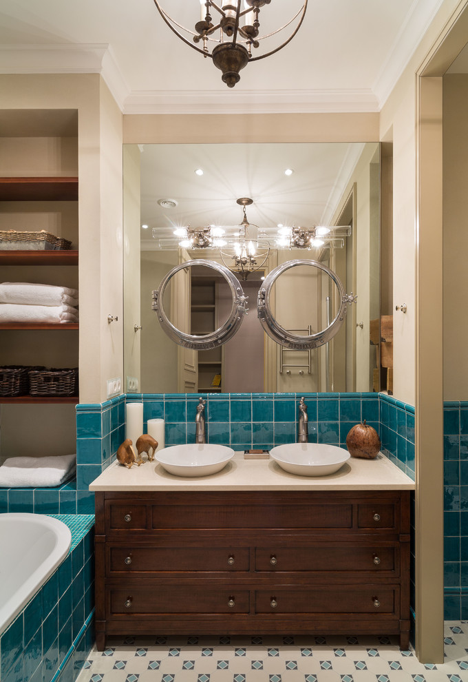 Идея дизайна: главная ванная комната в классическом стиле с фасадами цвета дерева среднего тона, накладной ванной, синей плиткой, керамической плиткой, бежевыми стенами, настольной раковиной и фасадами с утопленной филенкой